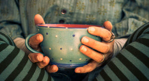 Close up of a woman's hands holding a cup.