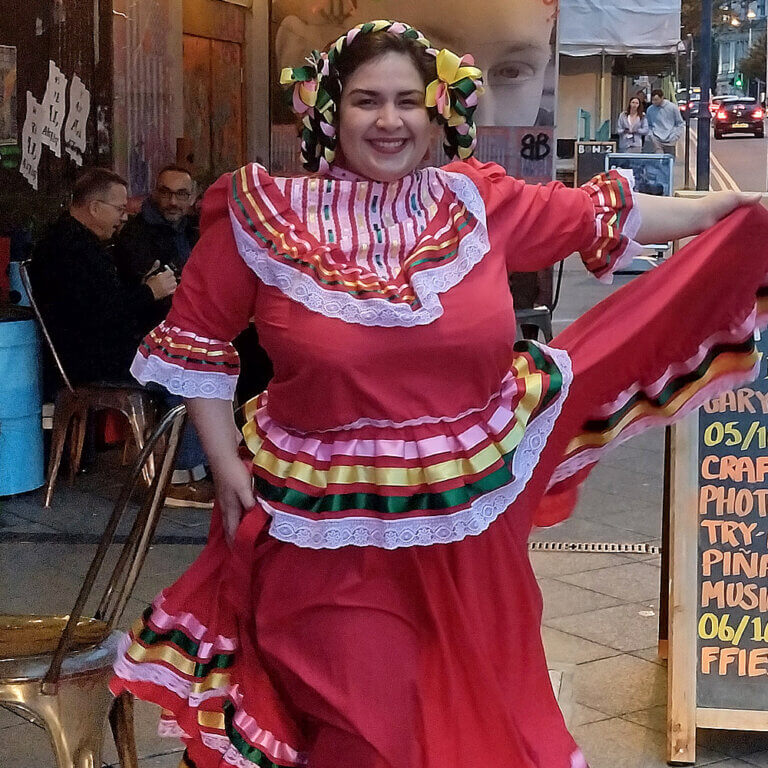 a woman dressed in a latin american dance costume
